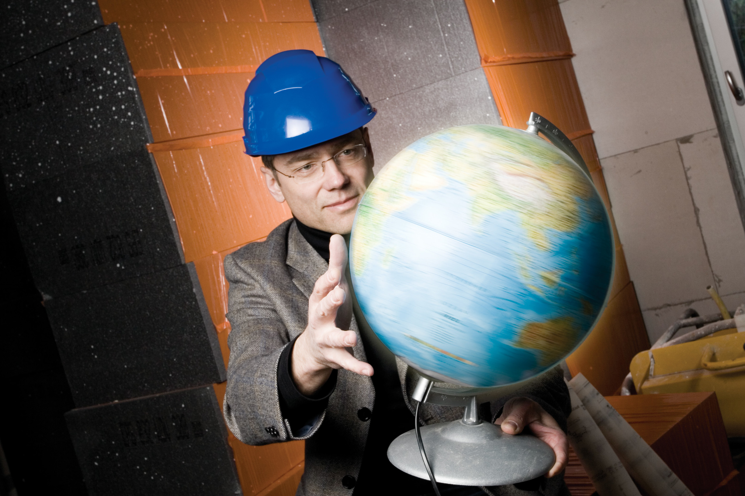 Construction manager with globe on construction site
