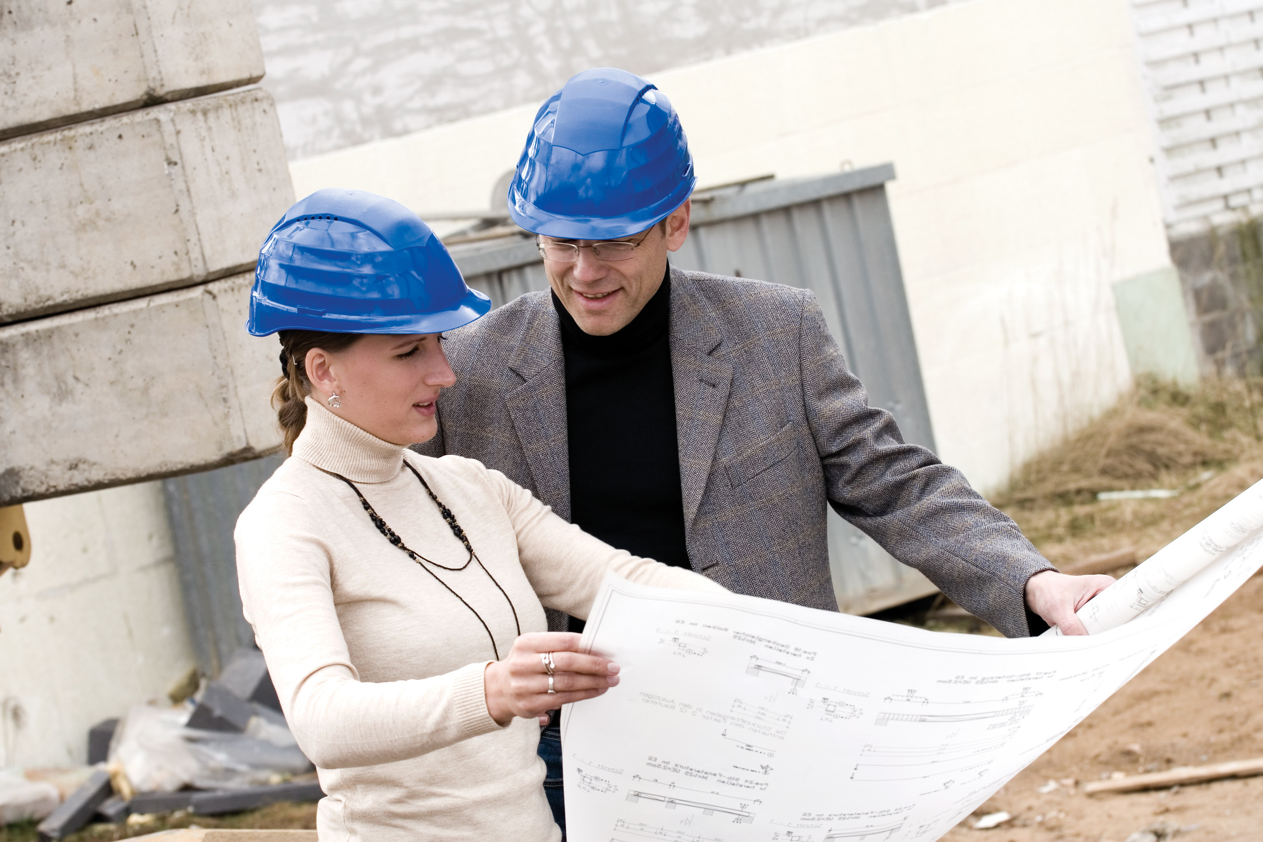 Construction manager with architect on construction site